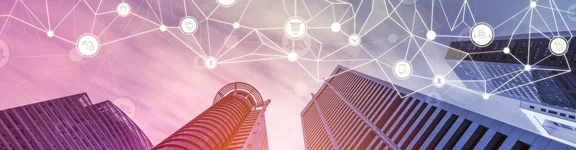 Das Bild zeigt zwei Hochhäuser von unten. Über den Hochhäusern sind verschiedene Icons, die die Vernetzung und Digitalisierung visualisieren sollen.