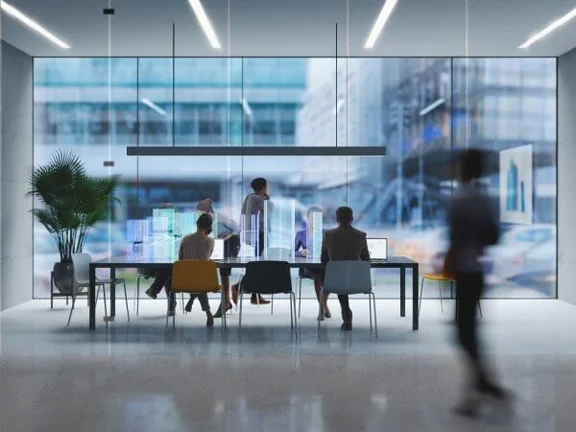 Eine Illustration von einem Besprechungsraum mit einer Glaswand, am Tisch sind einige Menschen am arbeiten an ihren Notebooks